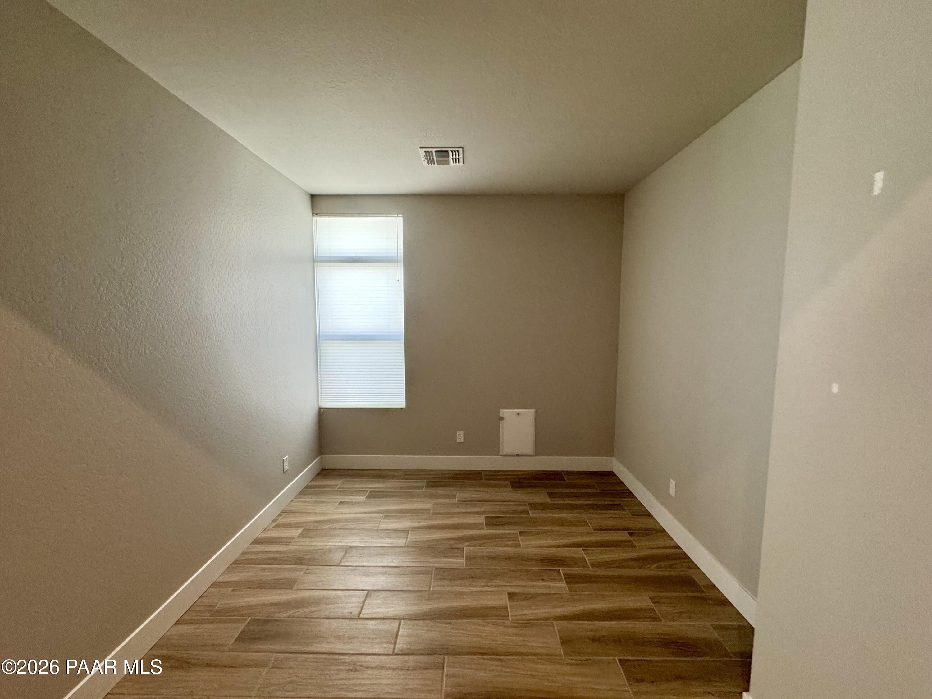 5556 East Killen Loop Prescott Valley, AZ 86314 - Photo 18 of 27 a view of empty room with wooden floor