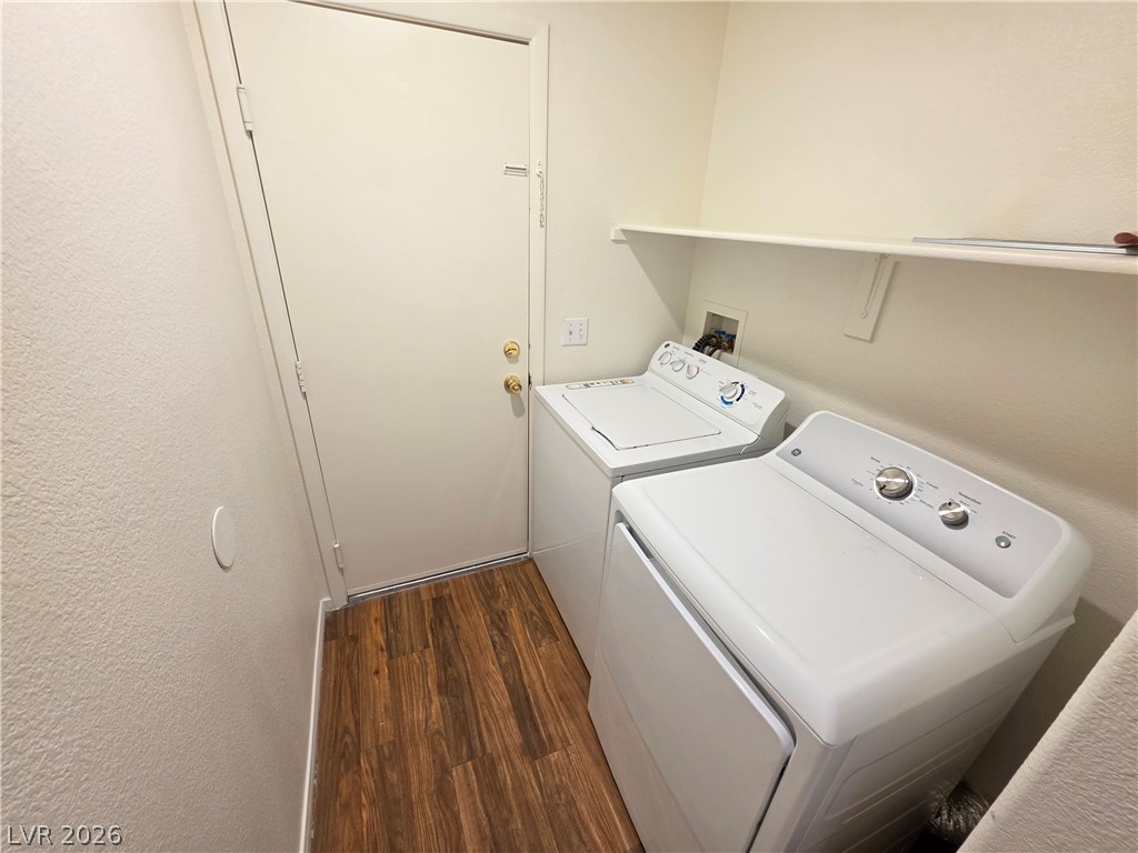 1154 Point Success Avenue Henderson, NV 89014 - Photo 11 of 26 A dedicated laundry room provides convenience with a washer and dryer, complemented by practical shelving for storage.