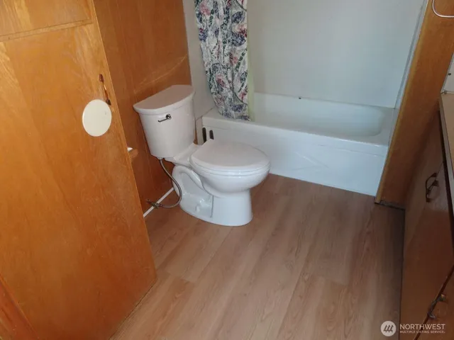 a white toilet sitting next to a small sink