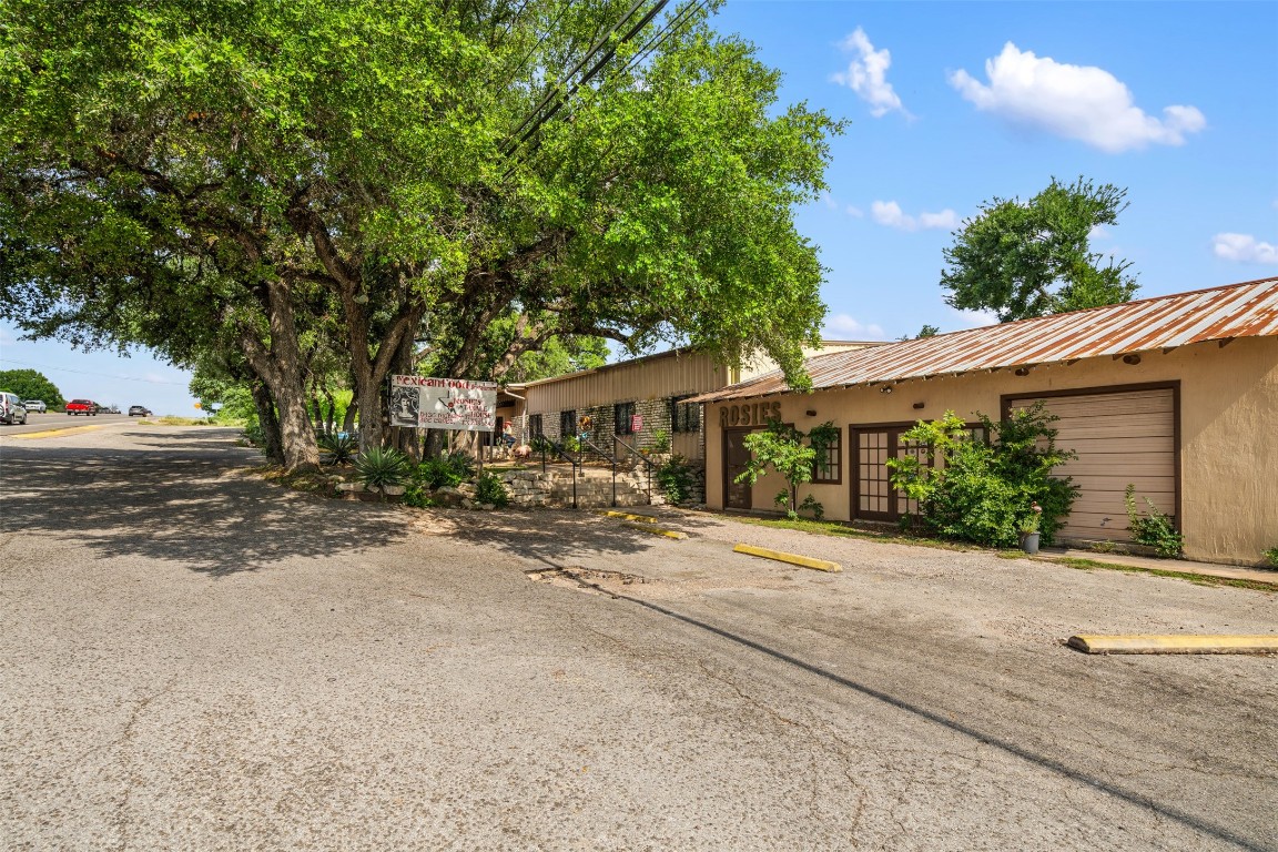 13436 State Highway 71 Bee Cave, TX 78738 - Photo 12 of 35 front view of a house with a street