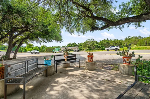 an outdoor sitting area with a tree