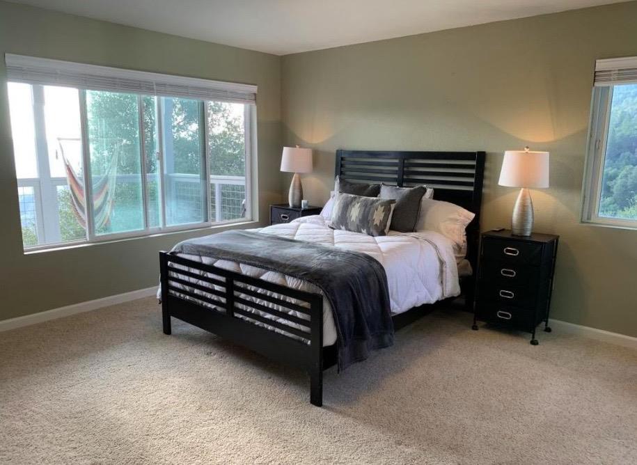 2235 Skunk Ranch Road Murphys, CA 95247 - Photo 12 of 22 a bedroom with a bed lamp and window