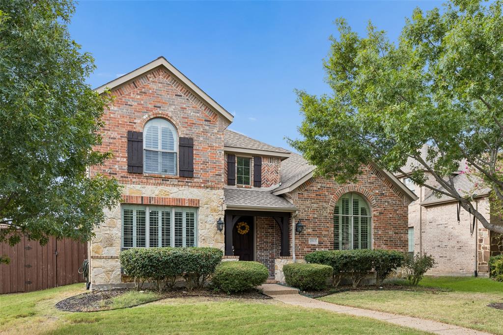 2865 Ridge View Road Frisco, TX 75034 - Photo 2 of 38 Brick and stone exterior with arched windows, dark shutters, and a covered entry