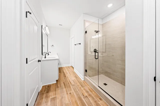 a view of a hallway with wooden floor and staircase