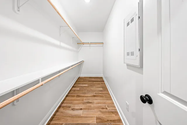 an empty room with a window and a ceiling fan