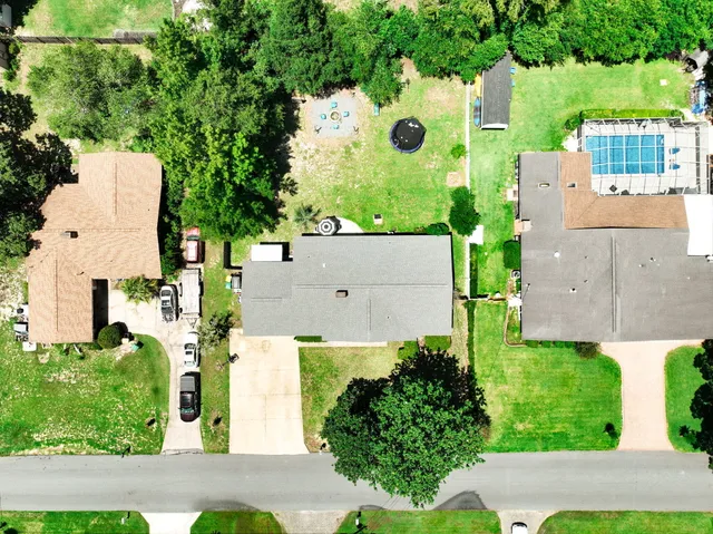 an aerial view of a house with yard