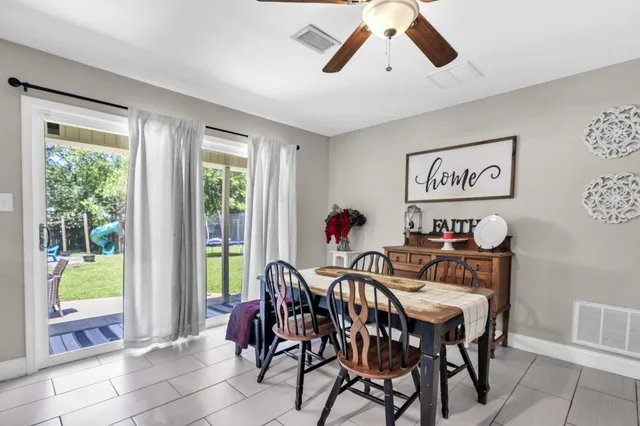 a view of a dining room with furniture and a chandelier