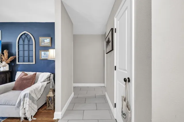 a living room with furniture ceiling fan and a window