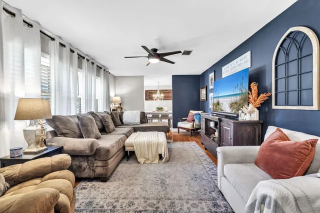 a living room with furniture gym equipment and a flat screen tv