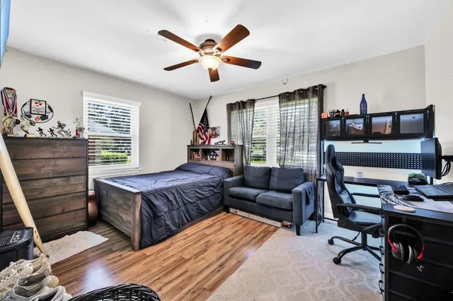 a bedroom with a bed and wooden floor