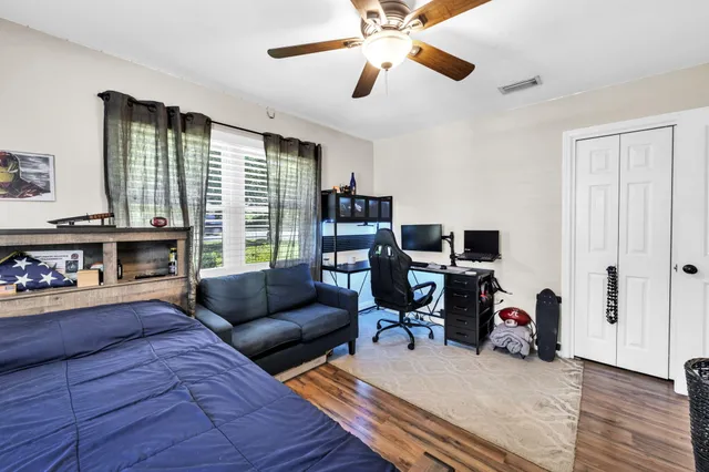 a bedroom with a bed and a desk