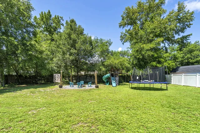 a front view of a house with a yard and a garden
