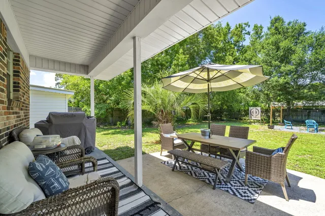 a view of a patio with chairs and a table