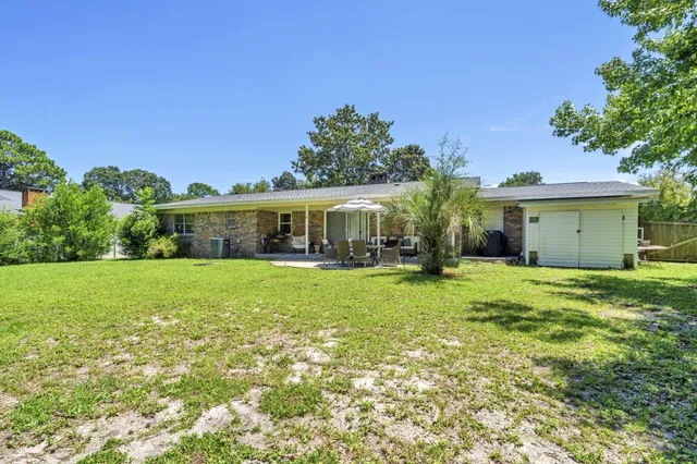 an aerial view of residential houses with outdoor space and trees