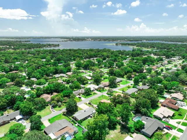 a view of a lake with a table and chairs