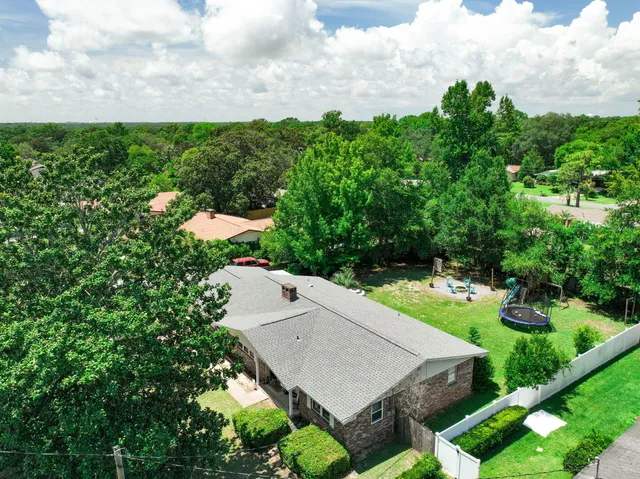an aerial view of a house with yard and outdoor seating