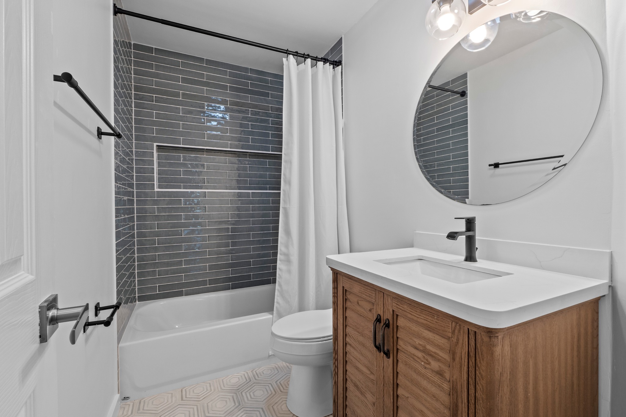 11811 Rotherham Drive Austin, TX 78754 - Photo 26 of 37 A well-appointed bathroom features a sleek vanity, modern fixtures, and an inviting shower with stylish subway tiling.