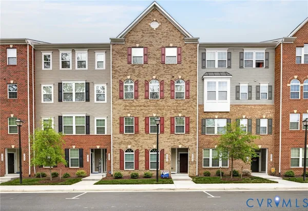 a front view of a residential apartment building with a yard