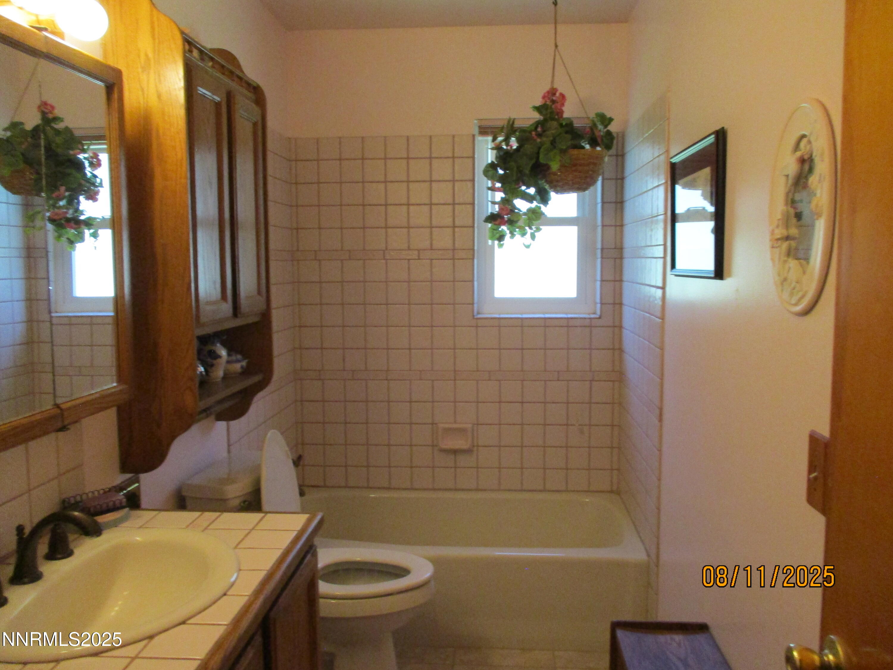 210 Modoc Drive Winnemucca, NV 89445 - Photo 15 of 25 a bathroom with a sink toilet and shower