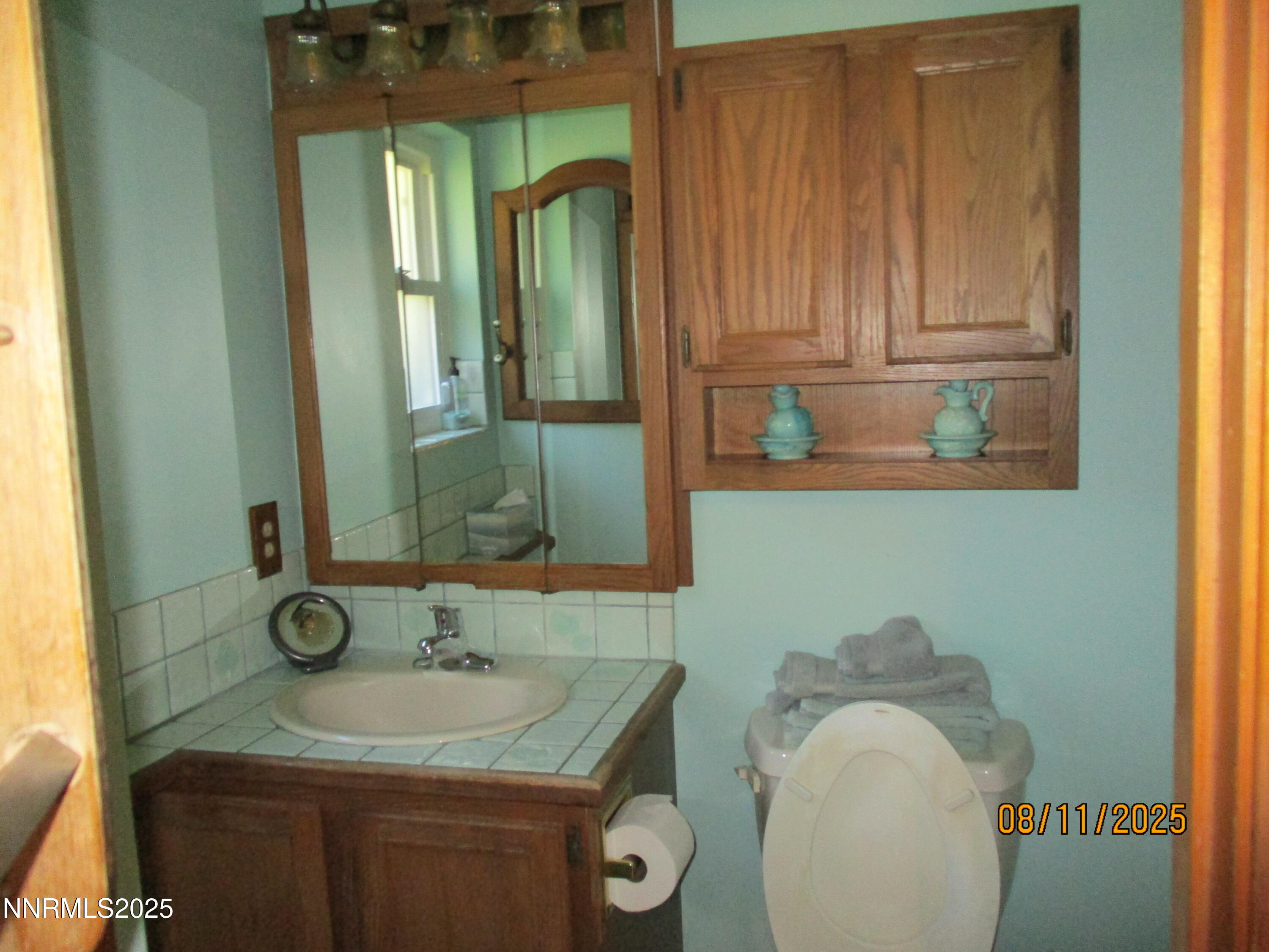 210 Modoc Drive Winnemucca, NV 89445 - Photo 16 of 25 a bathroom with a granite countertop sink and a mirror
