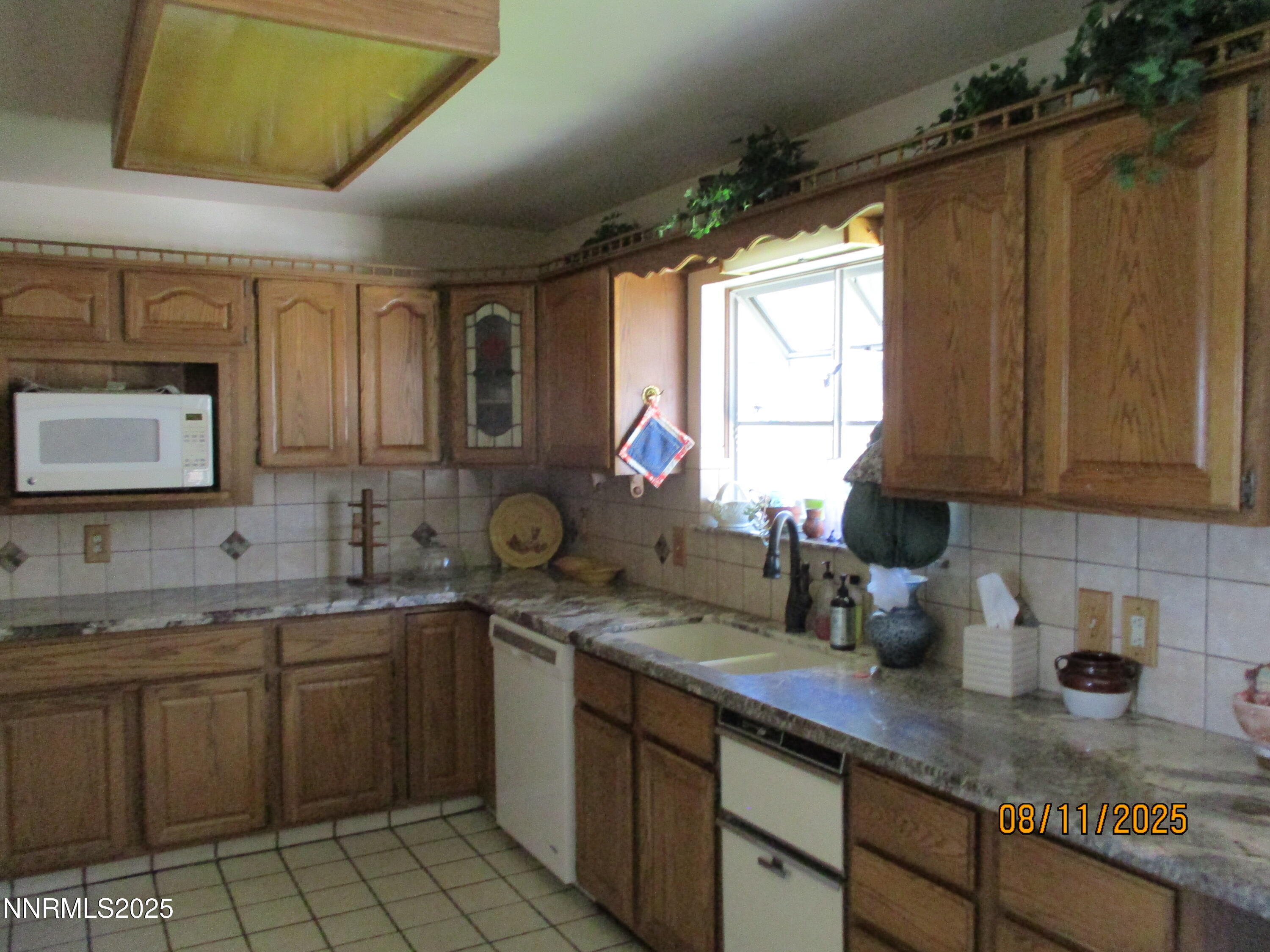 210 Modoc Drive Winnemucca, NV 89445 - Photo 20 of 25 a kitchen with a sink stove and cabinets