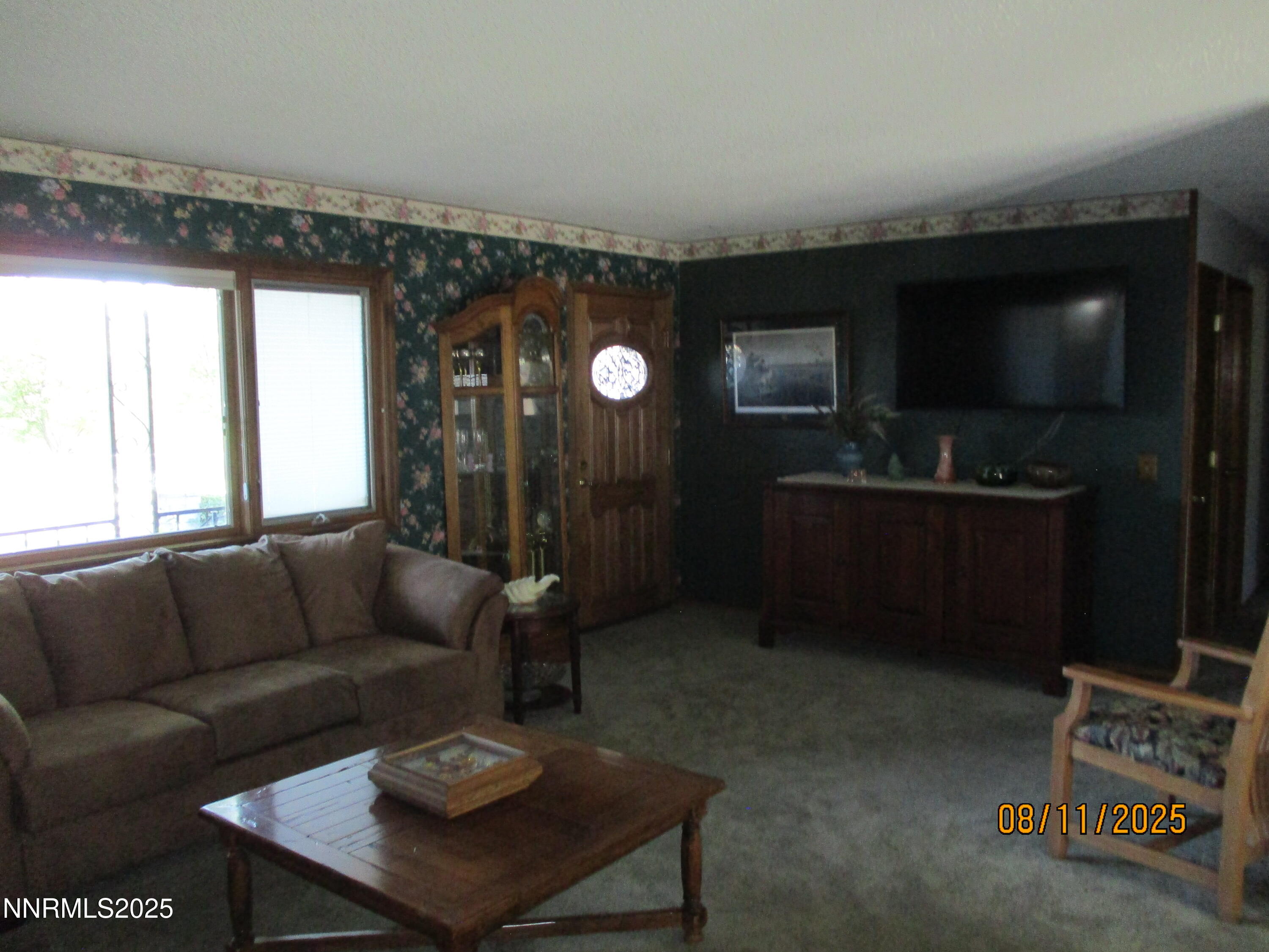 210 Modoc Drive Winnemucca, NV 89445 - Photo 21 of 25 a living room with furniture and a flat screen tv