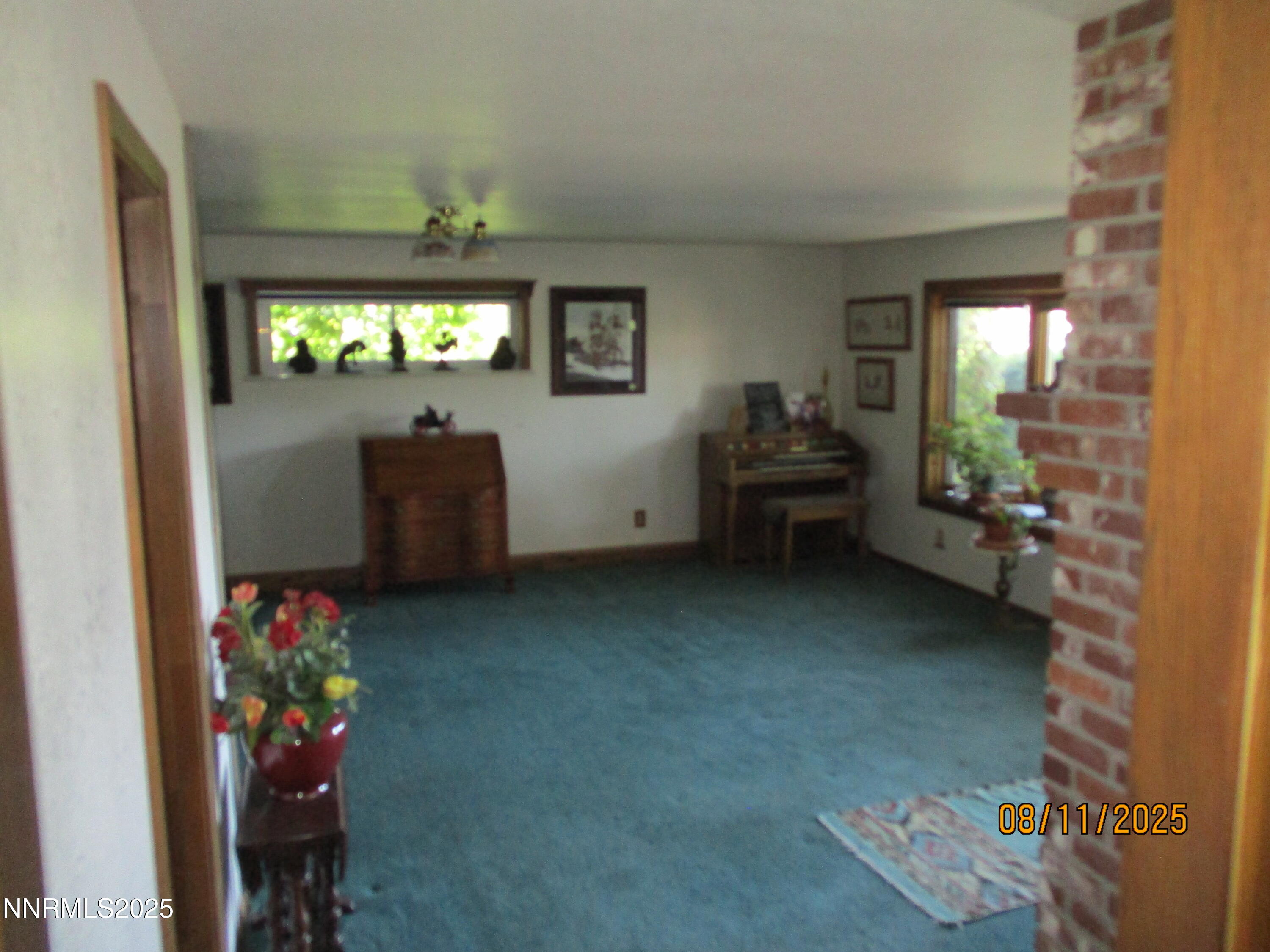210 Modoc Drive Winnemucca, NV 89445 - Photo 23 of 25 a living room with furniture and a chandelier