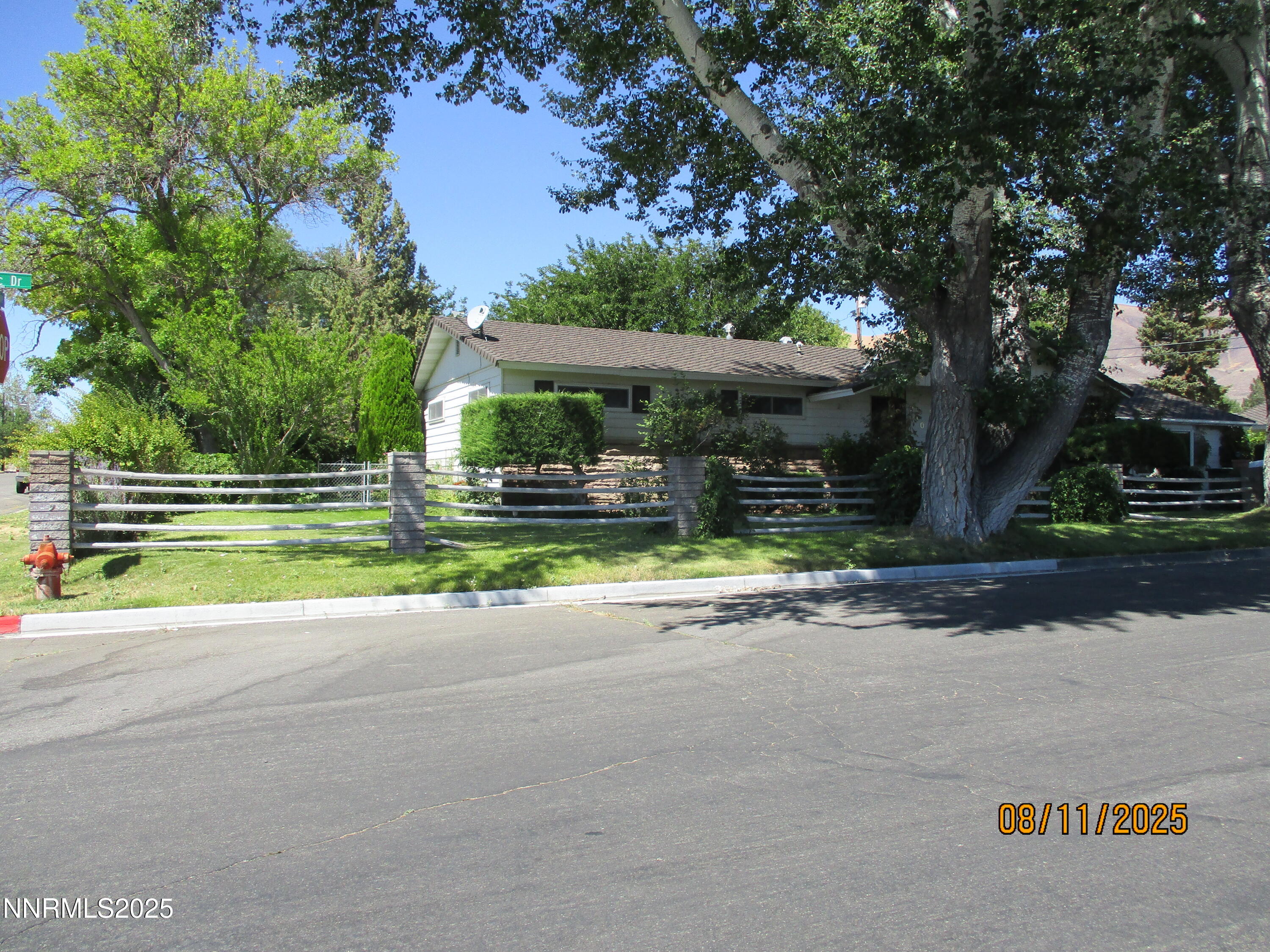 210 Modoc Drive Winnemucca, NV 89445 - Photo 3 of 25 a view of a house with a yard and large tree