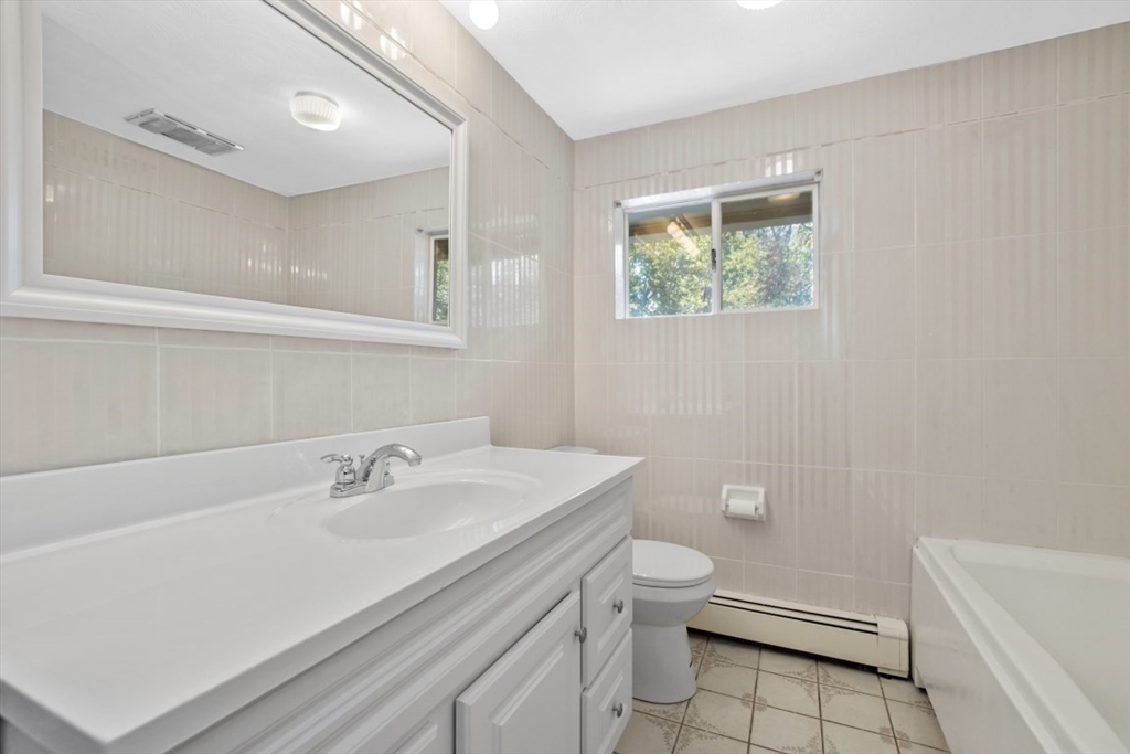 1704 Trapelo Road Waltham, MA 02451 - Photo 13 of 16 a bathroom with a sink a toilet a vanity and mirror