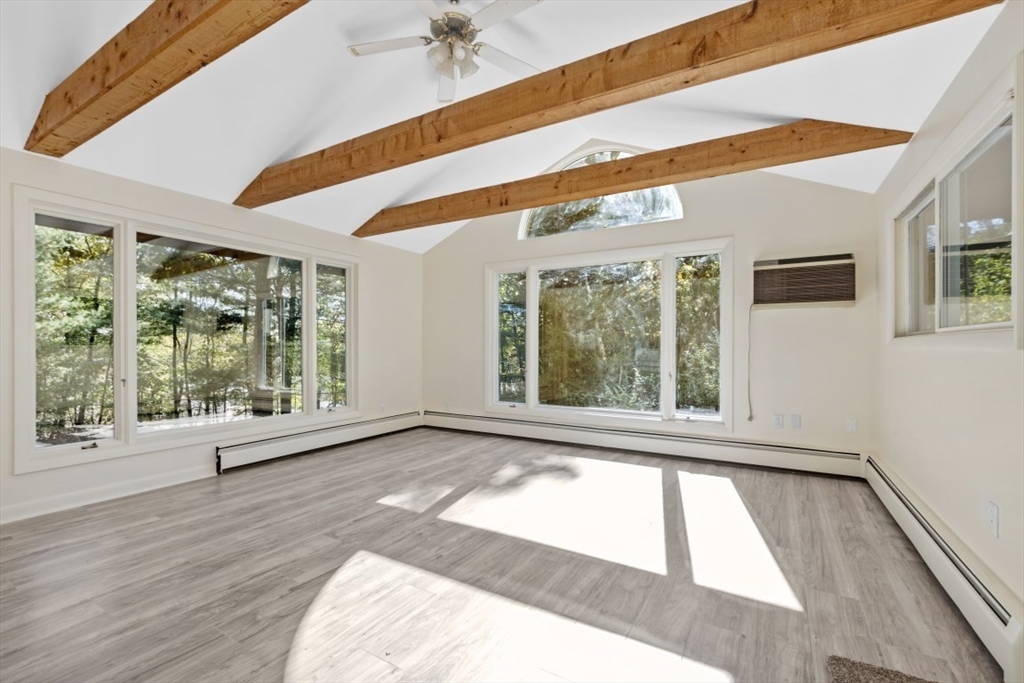 1704 Trapelo Road Waltham, MA 02451 - Photo 14 of 16 a view of an empty room with wooden floor and a window