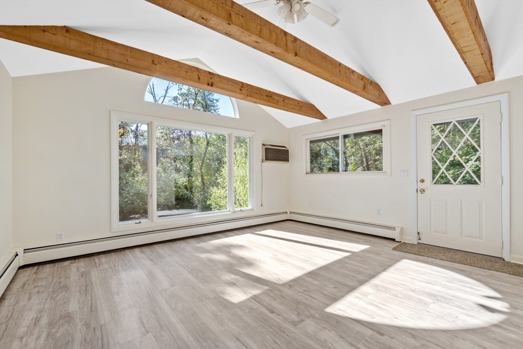 1704 Trapelo Road Waltham, MA 02451 - Photo 15 of 16 a view of an empty room with wooden floor and a window