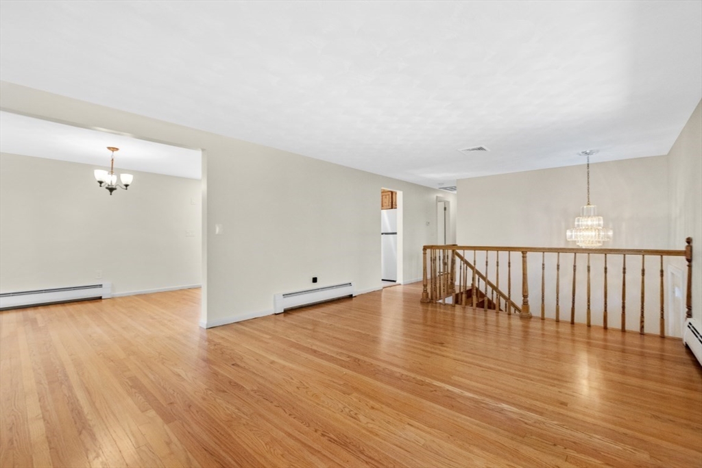 1704 Trapelo Road Waltham, MA 02451 - Photo 5 of 16 a view of an empty room with wooden floor