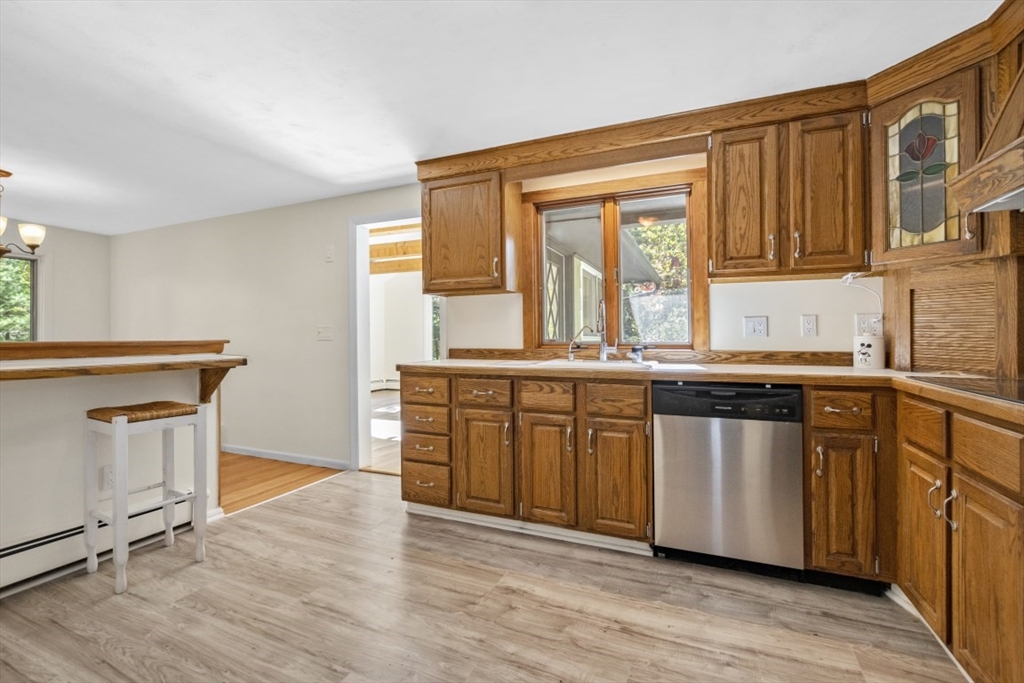 1704 Trapelo Road Waltham, MA 02451 - Photo 10 of 16 a kitchen with stainless steel appliances granite countertop a stove and a sink