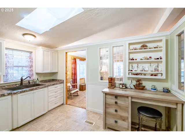 a living room with furniture a dining table and a chandelier