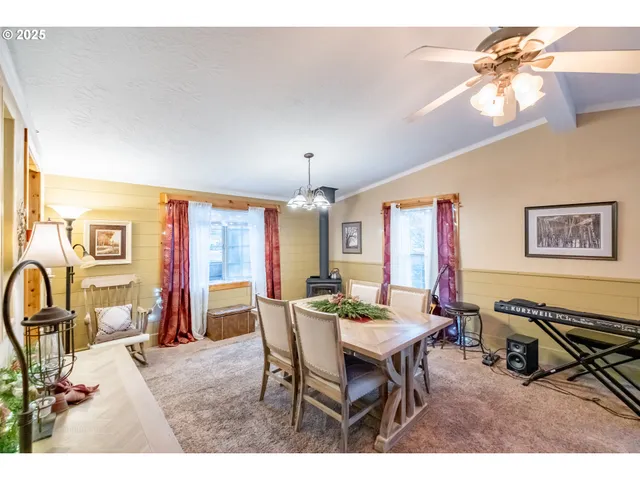 a view of a dining room with furniture and a chandelier