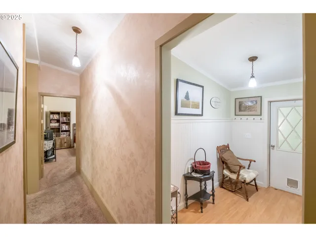 a view of a hallway with a livingroom and a couch