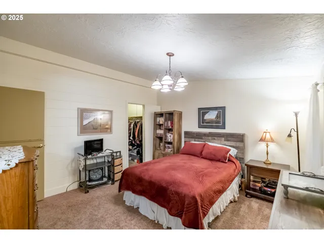 a bedroom with furniture and a chandelier