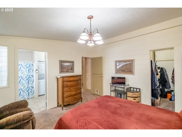 a bedroom with furniture and a chandelier