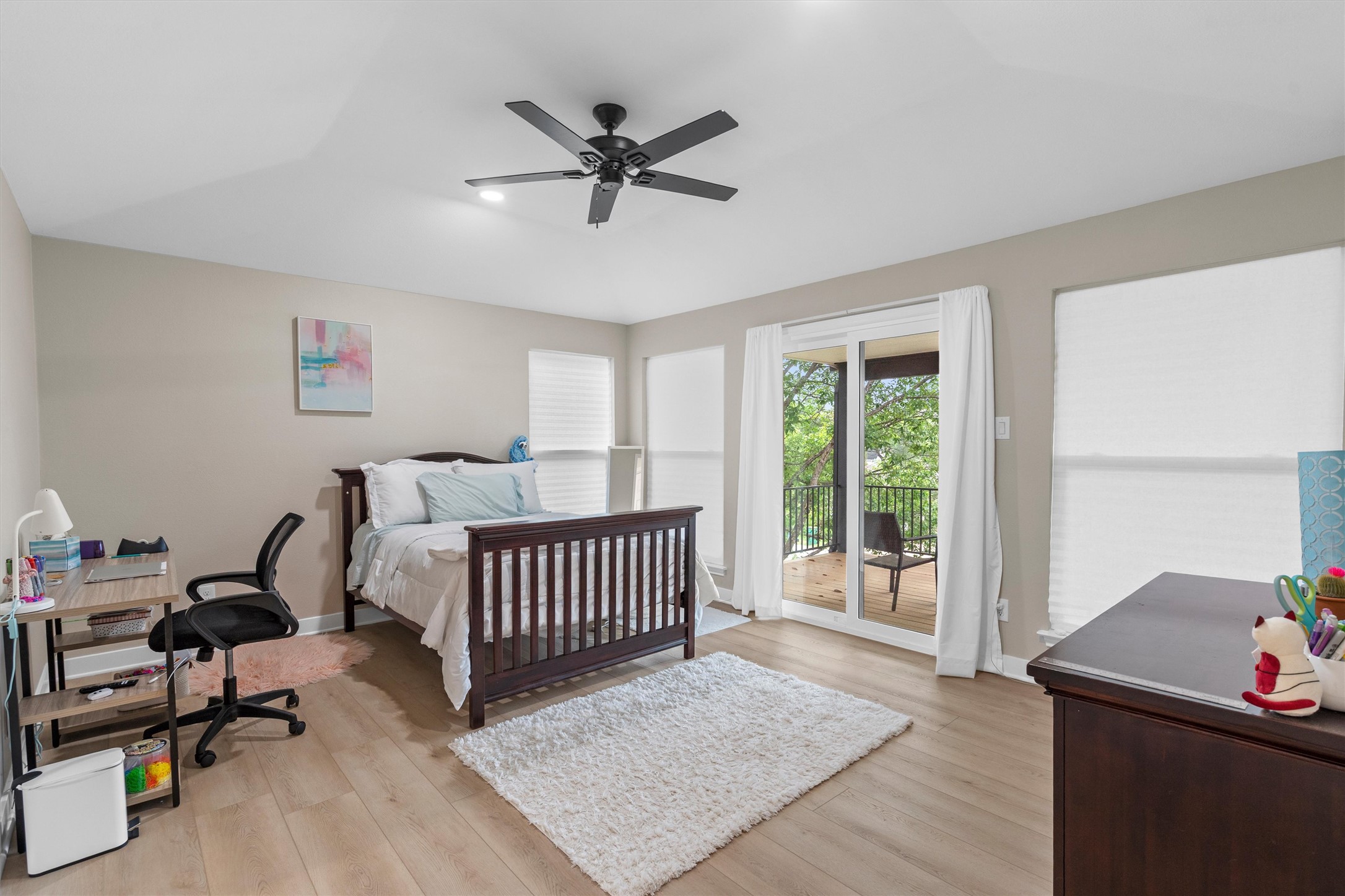 307 Hurst Creek Road Austin, TX 78734 - Photo 34 of 40 Spacious room featuring wood-finish flooring, neutral paint tones, and a ceiling fan with integrated lighting