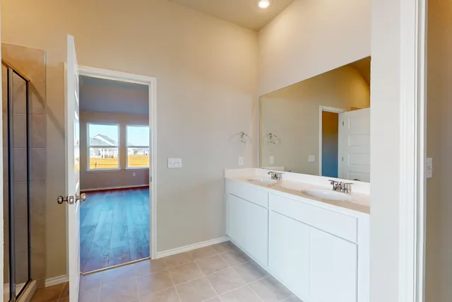 a en suite bathroom with a sink and mirror