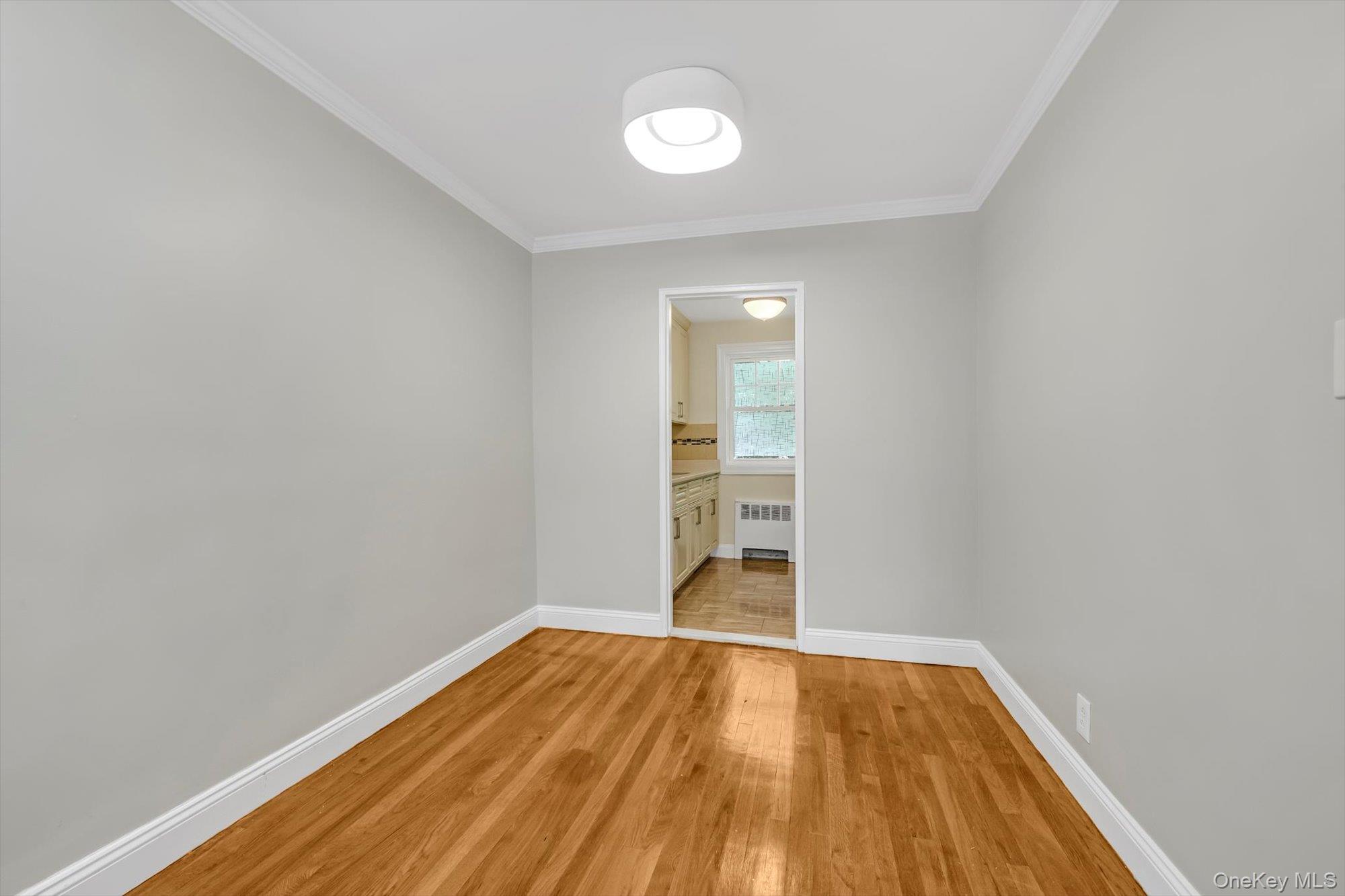 77-17 Springfield Boulevard, Unit B Queens, NY 11364 - Photo 5 of 11 a view of empty room with wooden floor