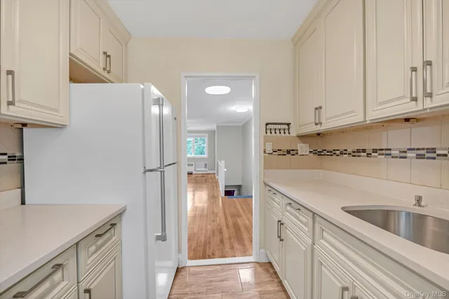 a kitchen with cabinets and stainless steel appliances