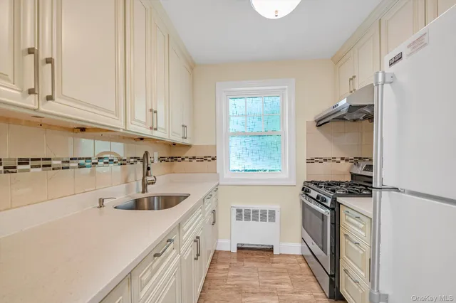a kitchen that has a sink and a stove
