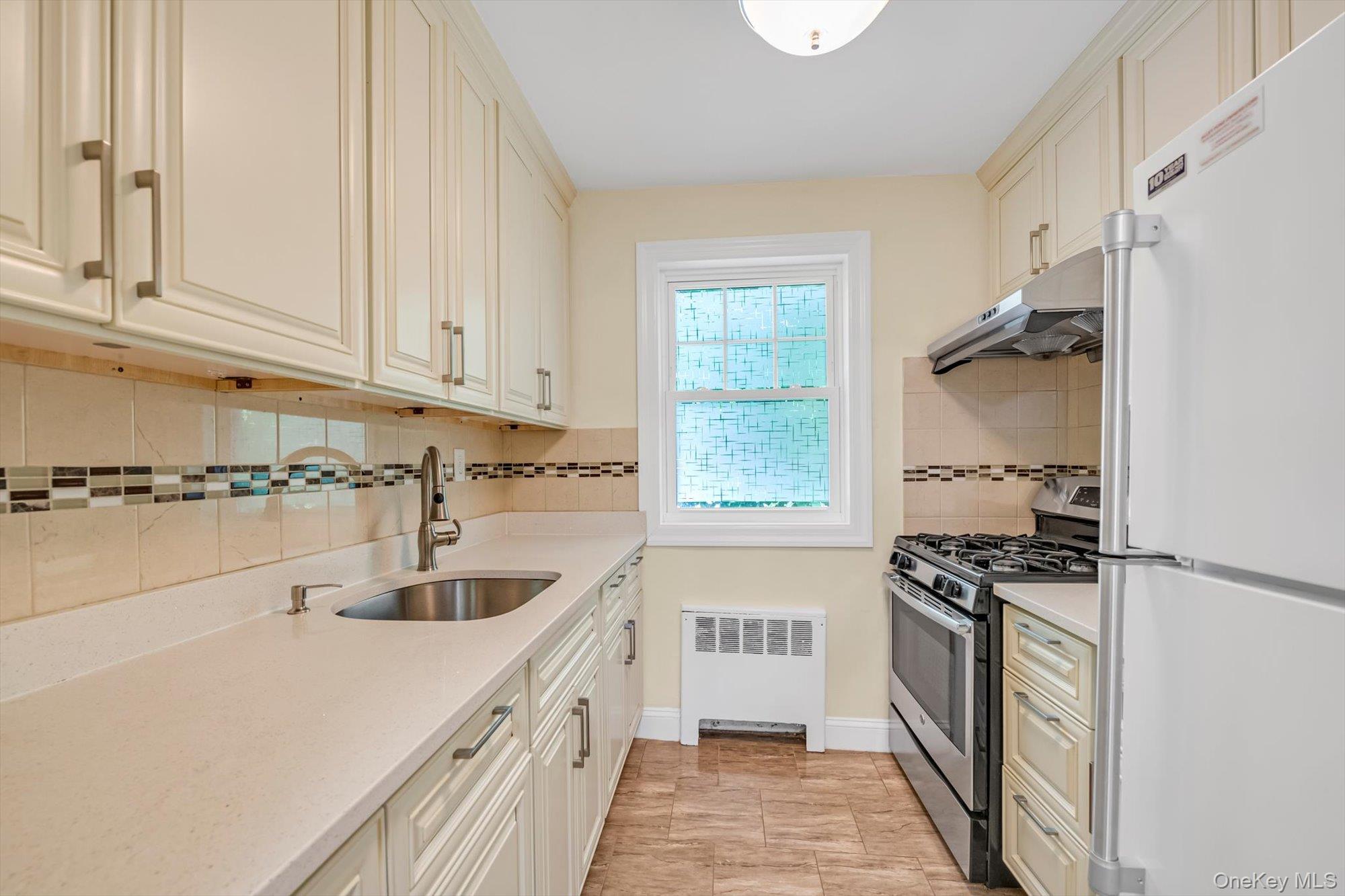 77-17 Springfield Boulevard, Unit B Queens, NY 11364 - Photo 7 of 11 a kitchen that has a sink and a stove