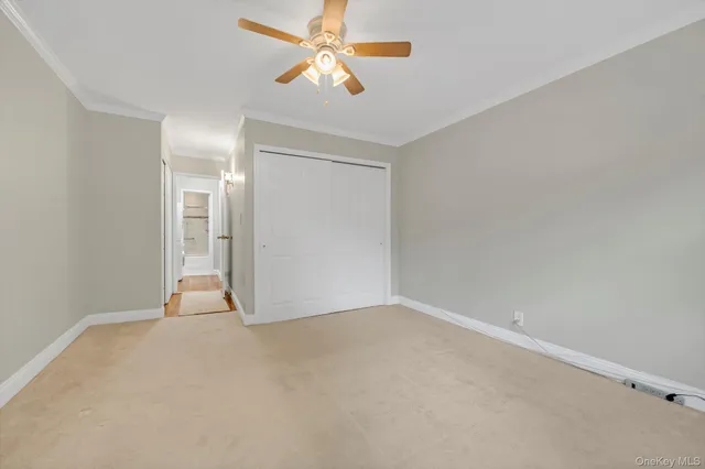 a view of an empty room and a ceiling fan