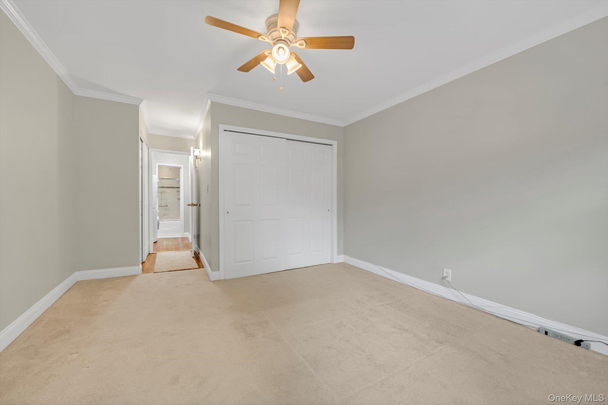77-17 Springfield Boulevard, Unit B Queens, NY 11364 - Photo 8 of 11 a view of an empty room and a ceiling fan