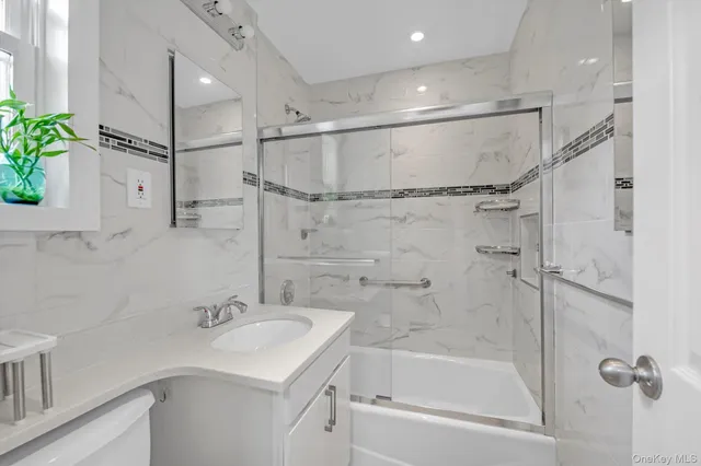 a bathroom with a sink shower and a mirror