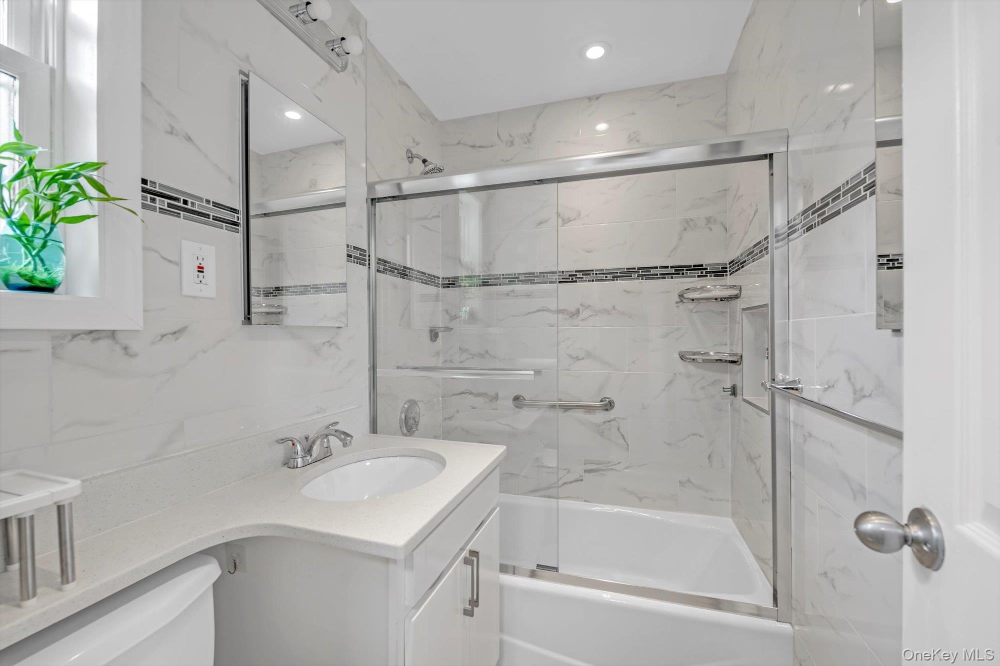 77-17 Springfield Boulevard, Unit B Queens, NY 11364 - Photo 10 of 11 a bathroom with a sink shower and a mirror