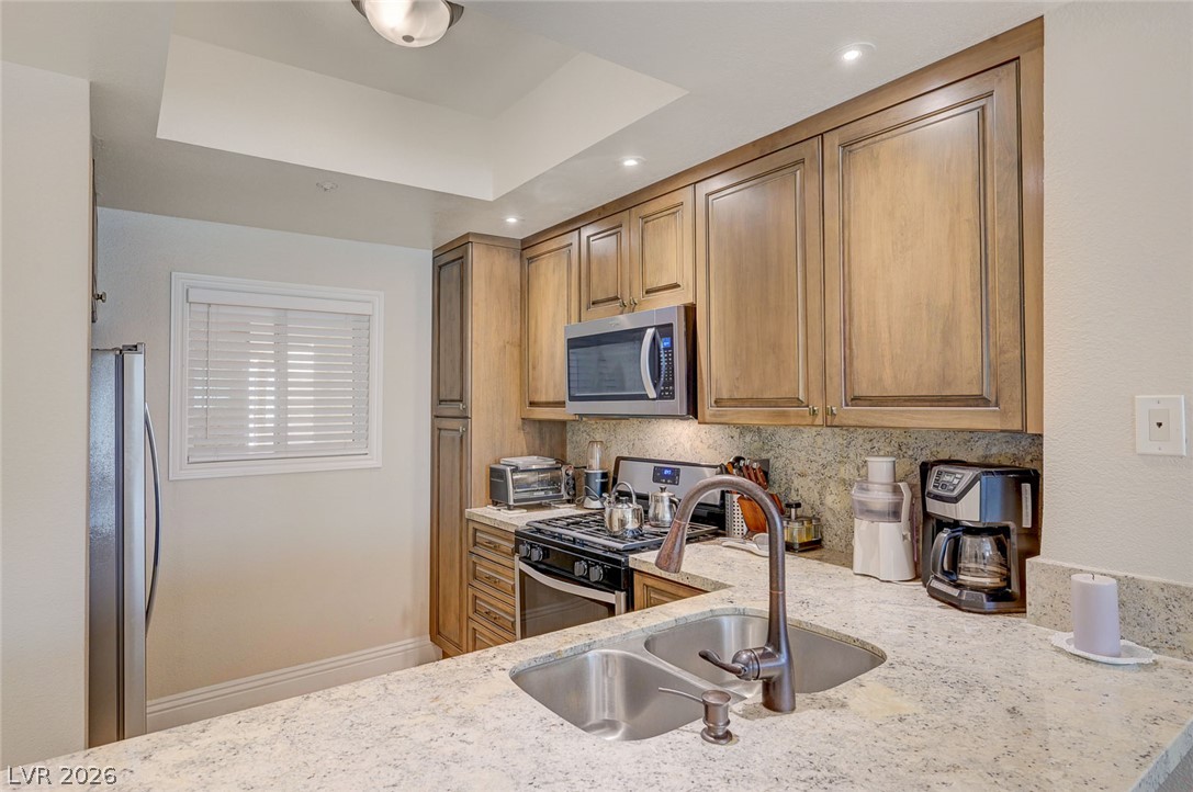 230 East Flamingo Road, Unit 106 Las Vegas, NV 89169 - Photo 7 of 66 A well-appointed culinary space featuring ample cabinetry and essential appliances.