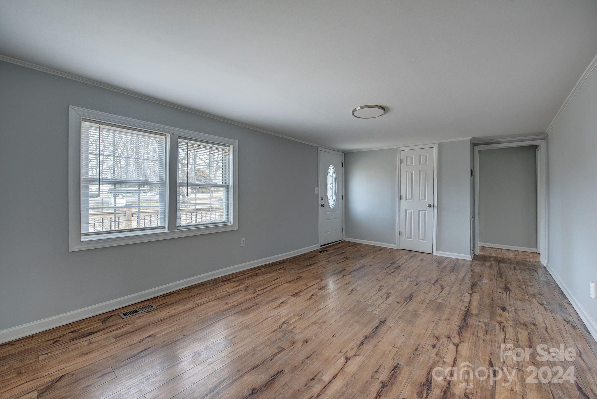 2714 Rufus Ratchford Road Gastonia, NC 28056 - Photo 12 of 28 a view of an empty room with wooden floor and a window